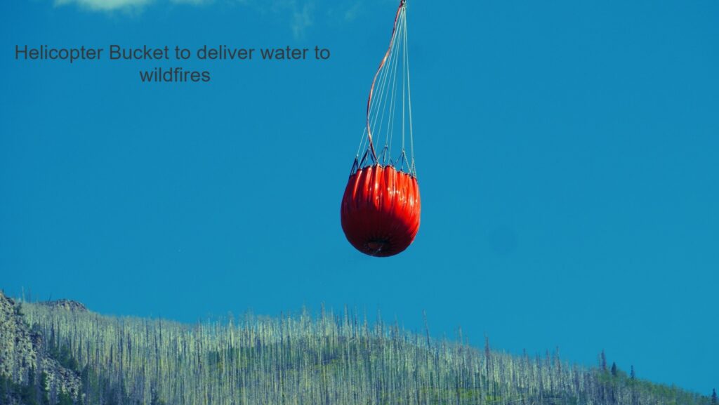 Helicopter bucket delivering water to fires